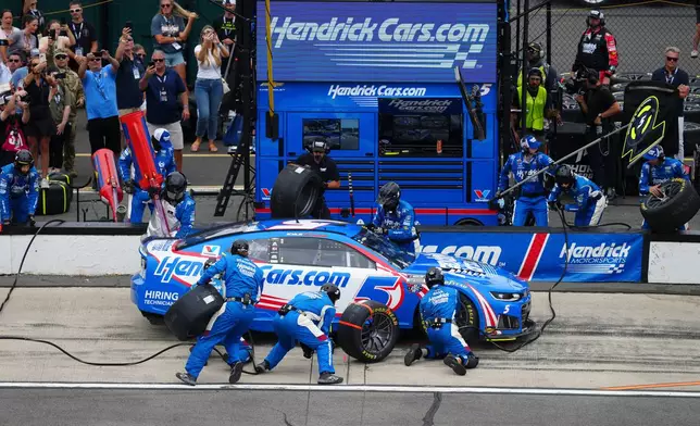 Kyle Larson makes a pitstop during a NASCAR Cup Series auto race at Pocono Raceway, Sunday, June 14, 2026, in Long Pond, Pa. (AP Photo/Derik Hamilton)