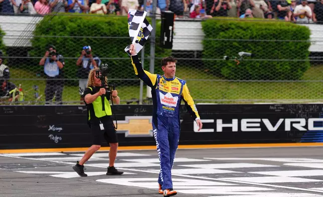 Denny Hamlin celebrates his win during a NASCAR Cup Series auto race at Pocono Raceway, Sunday, June 14, 2026, in Long Pond, Pa. (AP Photo/Derik Hamilton)