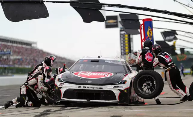 Christopher Bell makes a pitstop during a NASCAR Cup Series auto race at Pocono Raceway, Sunday, June 14, 2026, in Long Pond, Pa. (AP Photo/Derik Hamilton)