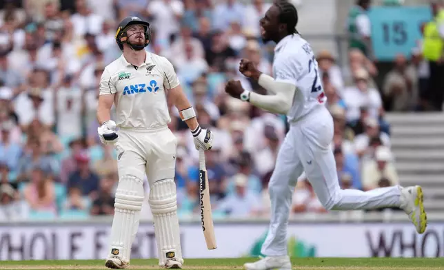 New Zealand's Glenn Phillips, left, reacts after being dismissed by England's Jofra Archer, right, on day four of the Second Rothesay Test cricket match between England and New Zealand in London, England, Saturday, June 20, 2026. (Ben Whitley/PA via AP)