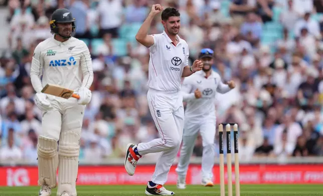 England's Josh Tongue, center, celebrates taking the wicket of New Zealand's Tom Blundell, left, on day four of the Second Rothesay Test cricket match between England and New Zealand in London, England, Saturday, June 20, 2026. (Ben Whitley/PA via AP)