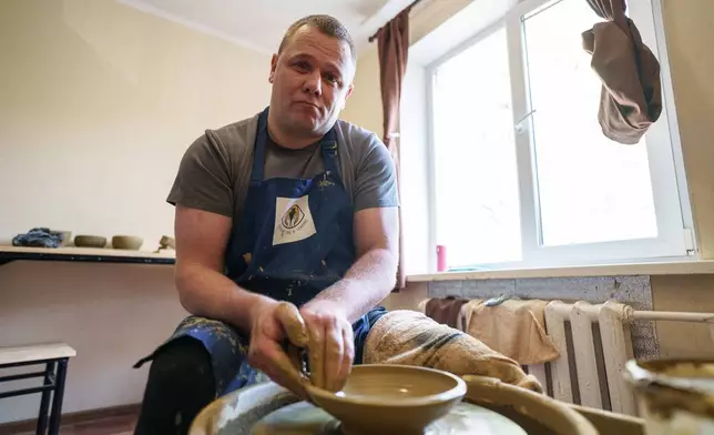 Ivan Shostak, a blind Ukrainian war veteran makes a clay plate on a pottery wheel at his apartment in Vinnytsia, Ukraine, on, May 21, 2026. (AP Photo/Evgeniy Maloletka)