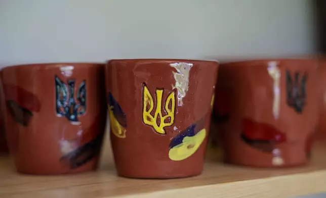 Clay cups decorated with Ukrainian triangle are seen inside apartments of blind Ukrainian war veteran Ivan Shostak in Vinnytsia, Ukraine, on May 21, 2026. (AP Photo/Evgeniy Maloletka)