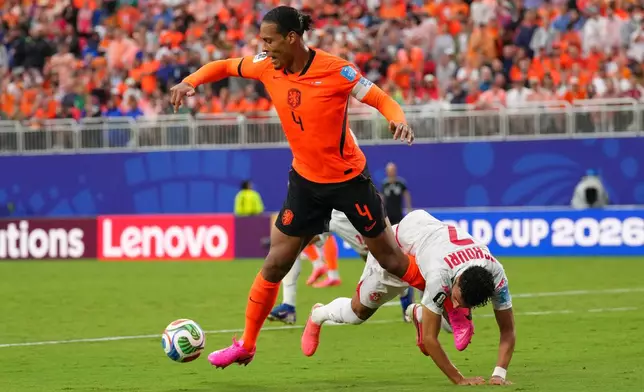Netherlands' Virgil van Dijk, left, vies for the ball with Tunisia's Elias Achouri during the World Cup Group F soccer match between Tunisia and the Netherlands in Kansas City, Mo., Thursday, June 25, 2026. (AP Photo/Ed Zurga)