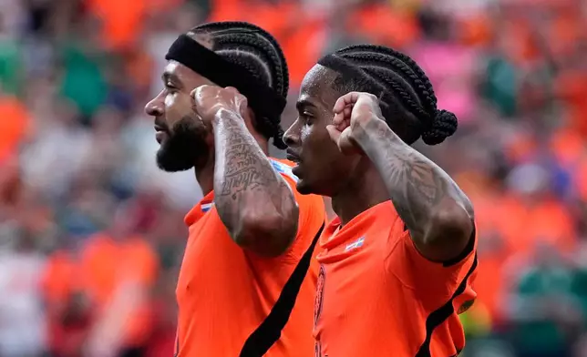 Netherlands' Crysencio Summerville celebrates with Memphis Depay, left, after scoring his side's fifth goal during the World Cup Group F soccer match between the Netherlands and Sweden in Houston, Saturday, June 20, 2026. (AP Photo/Ashley Landis)