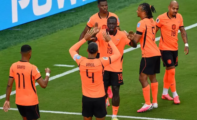 Netherlands' Brian Brobbey (19) celebrates their second goal with Virgil van Dijk (4) and teammates during the World Cup Group F soccer match between Tunisia and the Netherlands in Kansas City, Mo., Thursday, June 25, 2026. (AP Photo/Reed Hoffmann)