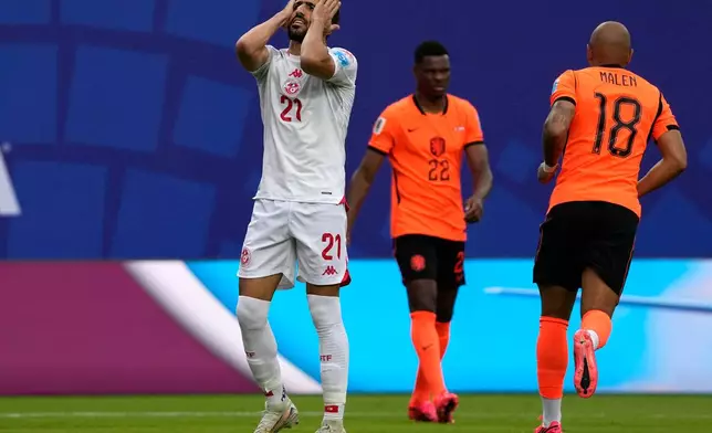 Tunisia's Mohamed Amine Ben Hmida (21) reacts to an own goal by teammate Ellyes Skhiri during the World Cup Group F soccer match between Tunisia and the Netherlands in Kansas City, Mo., Thursday, June 25, 2026. (AP Photo/Charlie Riedel)