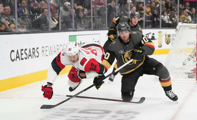 FILE - Carolina Hurricanes center Jesperi Kotkaniemi (82) collides with Vegas Golden Knights center Colton Sissons (10) during the second period of an NHL hockey game, Oct. 20, 2025, in Las Vegas. (AP Photo/Candice Ward, file)