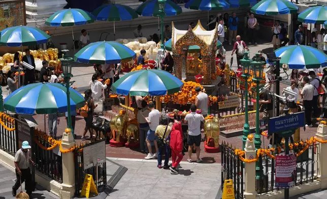 Visitors pray at the Erawan Shrine in Bangkok, Thailand, Wednesday, June 10, 2026. (AP Photo/Sakchai Lalit)