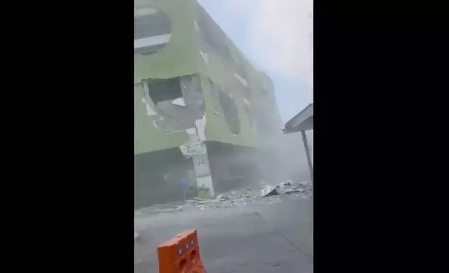 This image from a video shows dust and debris outside a building after a powerful earthquake in General Santos city on the island of Mindanao, Philippines Monday, June 8, 2026. (Ernesto Torres Jr via AP)