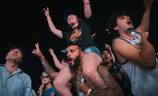 New York Knicks fans celebrate as they watch Game 5 of the NBA Finals basketball series against the San Antonio Spurs, Saturday, June 13, 2026, in New York. (AP Photo/Andres Kudacki)