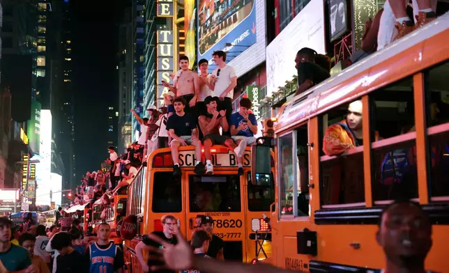 New York Knicks fans celebrate their victory after Game 5 of the NBA Finals basketball series against the San Antonio Spurs, Saturday, June 13, 2026, in New York. (AP Photo/Heather Khalifa)