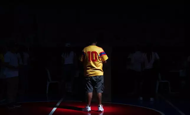 A voter wearing a national soccer team jersey waits for his turn to cast his ballot during the runoff election in Barranquilla, Colombia, Sunday, June 21, 2026. (AP Photo/Ivan Valencia)