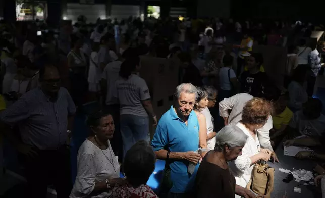Voters line up during the runoff presidential election in Barranquilla, Colombia, Sunday, June 21, 2026. (AP Photo/Ivan Valencia)