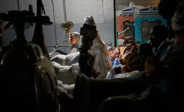 A figure of Chet Atkins and other parts of the Fox Trot Carousel are seen in a state government storage facility Wednesday, June 24, 2026, in Nashville, Tenn. (AP Photo/George Walker IV)