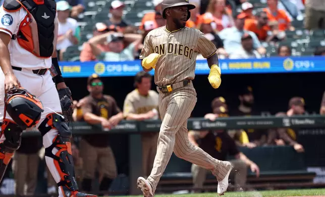 San Diego Padres' Samad Taylor scores during the second inning of a baseball game against the Baltimore Orioles, Sunday, June 14, 2026, in Baltimore. (AP Photo/Daniel Kucin Jr.)