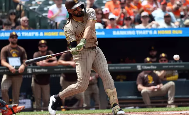 San Diego Padres' Fernando Tatis Jr. hits an RBI single during the second inning of a baseball game against the Baltimore Orioles, Sunday, June 14, 2026, in Baltimore. (AP Photo/Daniel Kucin Jr.)