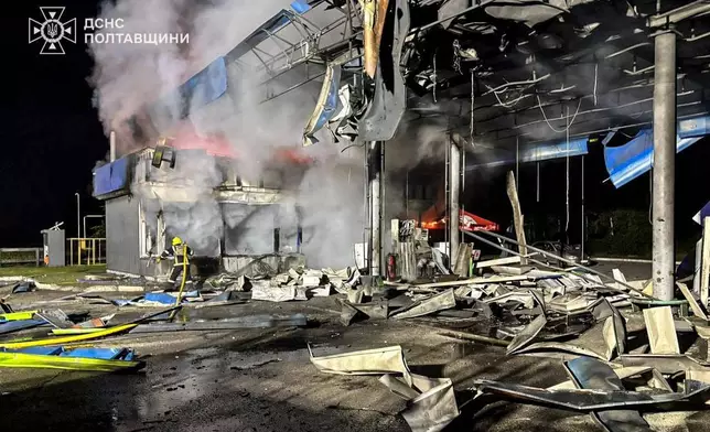 In this photo provided by the Ukrainian Emergency Services on Monday, June 29, 2026, a rescue worker puts out a fire of petrol station damaged by a Russian strike on Poltava region, Ukraine. (Ukrainian Emergency Service via AP)