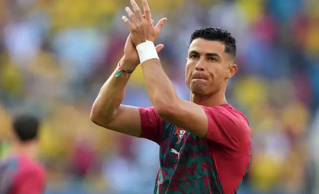 Portugal's Cristiano Ronaldo (7) applauds the crowd as he warms-up before the World Cup Group K soccer match between Colombia and Portugal in Miami Gardens, Fla., Saturday, June 27, 2026. (AP Photo/Lynne Sladky)