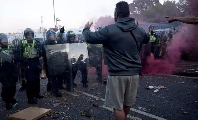 In this image taken from PA Video, police and protestors clash during a protest following the death of Henry Nowak, a 18-year-old student stabbed to death with a Sikh kirpan ceremonial by Vickrum Digwa, in Southampton, England, Tuesday June 2, 2026. (Jamie Lashmar/PA via AP)