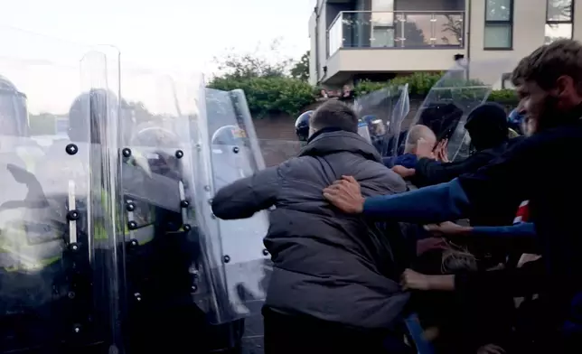 In this image taken from PA Video, police and protestors clash during a protest following the death of Henry Nowak, a 18-year-old student stabbed to death with a Sikh kirpan ceremonial by Vickrum Digwa, in Southampton, England, Tuesday June 2, 2026. (Jamie Lashmar/PA via AP)
