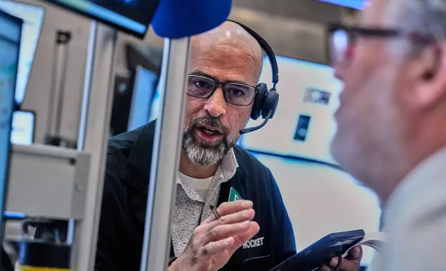 Options traders Steven Rodriguez, left, and Marty Handler work on the floor of the New York Stock Exchange, Wednesday, June 3, 2026. (AP Photo/Richard Drew)