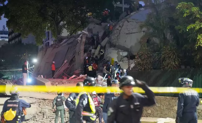 Rescue workers search for survivor at a collapsed building after an earthquake in Caracas, Venezuela, Wednesday, June 24, 2026. (AP Photo/Ariana Cubillos)