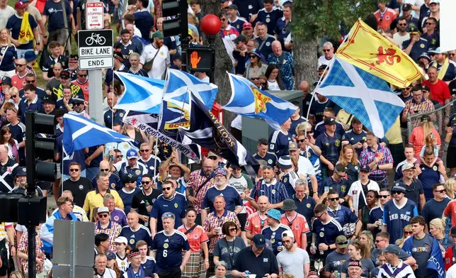 Scotland soccer fans take part in the Tartan Army March, making their way to Fenway Park ahead of a baseball game between the Boston Red Sox and the Texas Rangers, Sunday, June 14, 2026, in Boston. (AP Photo/Mark Stockwell)