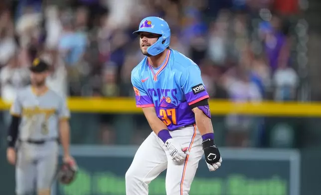Colorado Rockies pinch hitter Braxton Fulford celebrates after his two-run double off Pittsburgh Pirates relief pitcher Mason Montgomery in the eighth inning of a baseball game Friday, June 19, 2026, in Denver. (AP Photo/David Zalubowski)