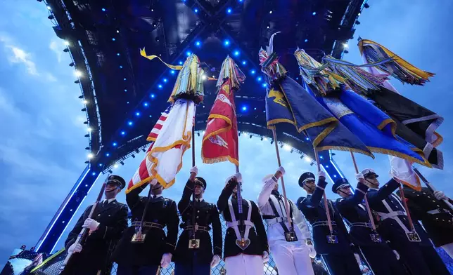 A joint forces honor guard stands during the National Anthem before UFC Freedom 250 on the South Lawn of the White House, Sunday, June 14, 2026, in Washington. (AP Photo/Alex Brandon)