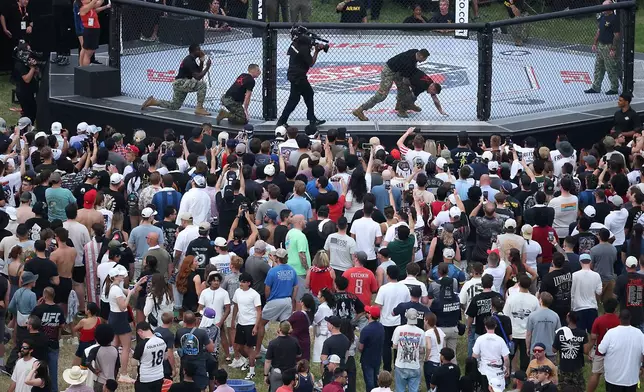 Army soldiers hold a grappling demonstration during the UFC Freedom 250 Fan Fest on The Ellipse ahead of the UFC Freedom 250 fight on the South Lawn of the White House on Sunday, June 14, 2026, in Washington. (Kevin Dietsch/Pool Photo via AP)