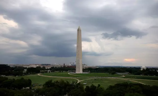Storm clouds move above the Washington Monument ahead of the UFC Freedom 250 fight on the South Lawn of the White House on Sunday, June 14, 2026, in Washington. (Kevin Dietsch/Pool Photo via AP)