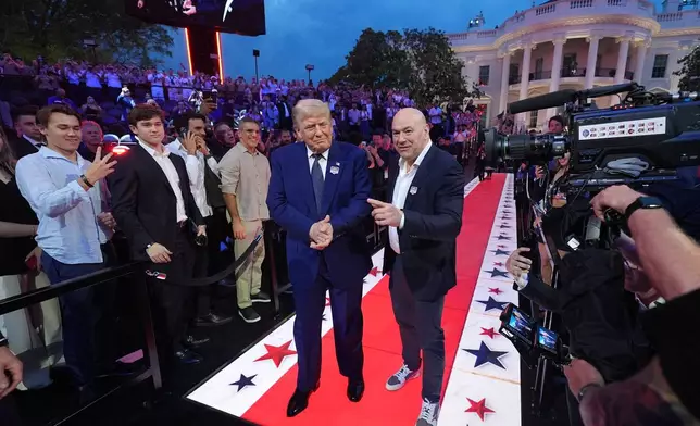 President Donald Trump and Dana White, UFC president and CEO, arrive for UFC Freedom 250 on the South Lawn of the White House, Sunday, June 14, 2026, in Washington. (AP Photo/Alex Brandon)