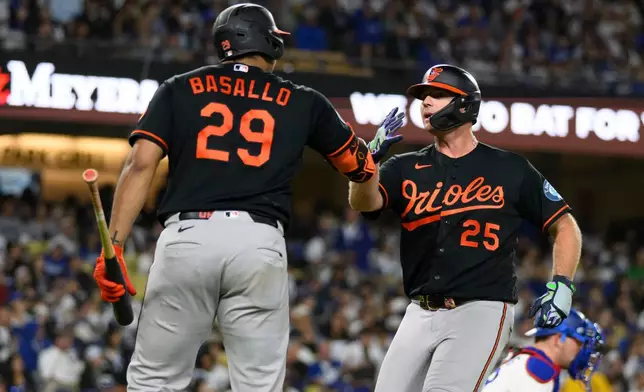Baltimore Orioles' Pete Alonso, right, celebrates his solo home run with Samuel Basallo during the sixth inning of a baseball game against the Los Angeles Dodgers in Los Angeles, Friday, June 19, 2026. (AP Photo/Kyusung Gong)