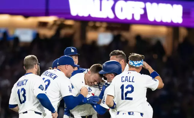 Los Angeles Dodgers players celebrate a walk-off single by Dalton Rushing in a baseball game against the Baltimore Orioles in Los Angeles, Friday, June 19, 2026. (AP Photo/Kyusung Gong)