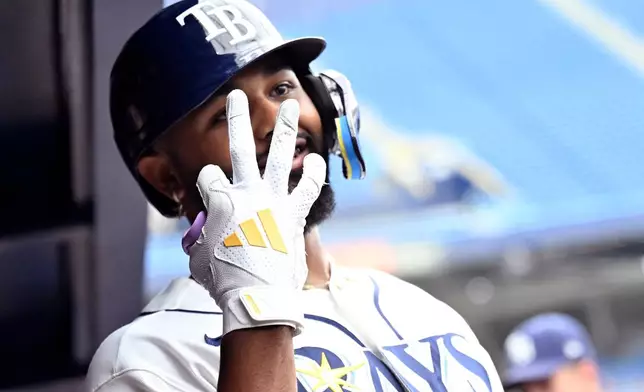 Tampa Bay Rays' Junior Caminero signals three as he celebrates his three-run home run during the eighth inning of a baseball game against the Kansas City Royals, Thursday, June 25, 2026, in St. Petersburg, Fla. Caminero had three home runs during the game. (AP Photo/Jason Behnken)