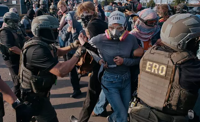Protesters confront ICE agents outside the Delaney Hall detention center while demonstrating near the entrance gates, Wednesday, May 27, 2026, in Newark, N.J. (AP Photo/Andres Kudacki)