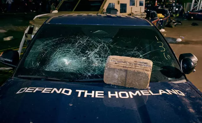 A brick sits on the hood of a damaged Department of Homeland Security vehicle outside the Delaney Hall detention center following a protest Friday, May 29, 2026, in Newark, N.J. (AP Photo/Andres Kudacki)