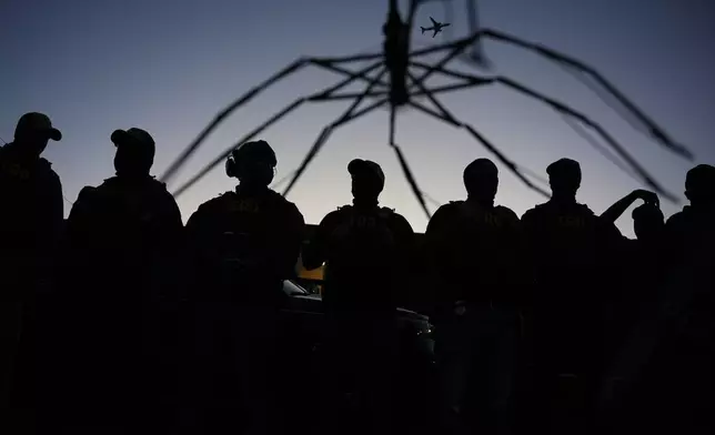 A broken umbrella is seen after federal immigration officers ripped the fabric off as they confront protesters outside Delaney Hall detention center Thursday, May 28, 2026, in Newark, N.J. (AP Photo/Angelina Katsanis)