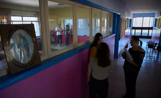 Teachers stand in a hallway at a school in the southern village of Qlayaa, Lebanon, Wednesday, June 10, 2026. (AP Photo/Hassan Ammar)