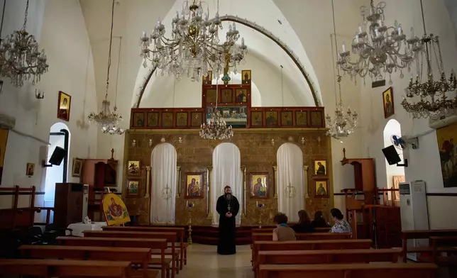 Father Philip Habib Okla, priest of St. Georges Orthodox Church, speaks inside the church in the southern town of Marjayoun, Lebanon, Wednesday, June 10, 2026. (AP Photo/Hassan Ammar)