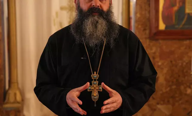 Father Philip Habib Okla, priest of St. Georges Orthodox Church, speaks inside the church in the southern town of Marjayoun, Lebanon, Wednesday, June 10, 2026. (AP Photo/Hassan Ammar)