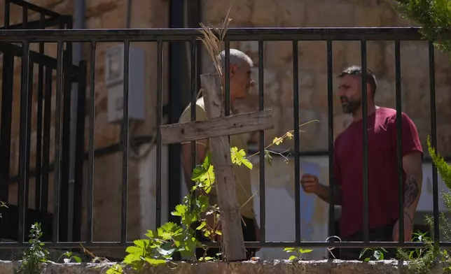 A wooden cross stands outside St. Georges Orthodox Church in the southern town of Marjayoun, Lebanon, Wednesday, June 10, 2026. (AP Photo/Hassan Ammar)
