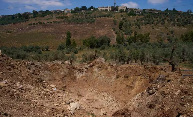 A crater caused by an Israeli airstrike is seen in the village of Dibbine, southeast Lebanon, Thursday, June 11, 2026. (AP Photo/Hassan Ammar)