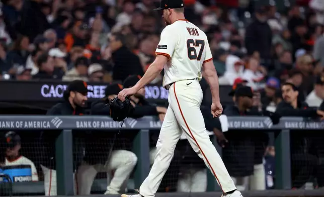 San Francisco Giants pitcher Keaton Winn (67) walks back to the dugout during the ninth inning of a baseball game against the Washington Nationals in San Francisco, Monday, June 8, 2026. (AP Photo/Jed Jacobsohn)