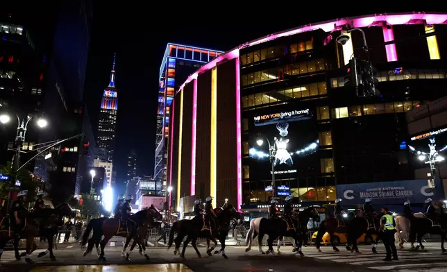 FILE - New York City police on horseback patrol the street by Madison Square Garden during Game 5 of the NBA Finals basketball series against the San Antonio Spurs, June 13, 2026, in New York. (AP Photo/Heather Khalifa, File)