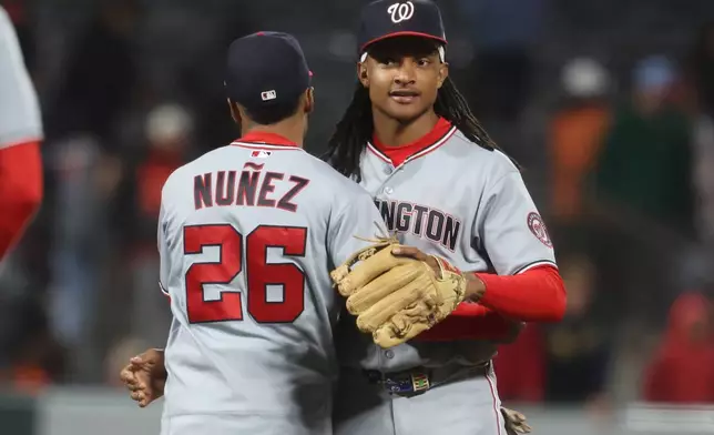 Washington Nationals shortstop CJ Abrams, right, and Nasim Nuñez (26) celebrate their team's victory over the San Francisco Giants at a baseball game in San Francisco, Tuesday, June 9, 2026. (AP Photo/Jed Jacobsohn)