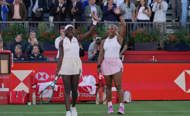 Serena Williams of the United States, celebrates with playing partner Victoria Mboko of Canada after defeating Nicole Melichar-Martinez of Canada and Erin Routliffe of New Zealand during their first round doubles match at the Queen's Club tennis championships in London, Tuesday, June 9, 2026. (AP Photo/Alberto Pezzali)