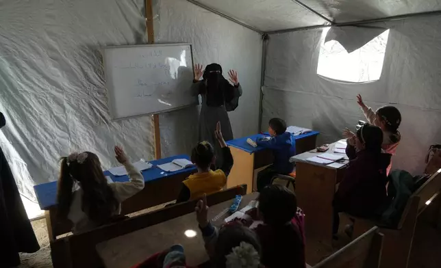 Palestinian children attend class in a tent classroom at an orphanage camp in Khan Younis, southern Gaza Strip, Thursday, Feb. 12, 2026. (AP Photo/Jehad Alshrafi)