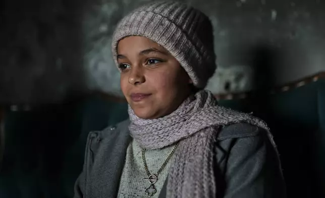 Razan Sharif Hamdi Shanan, 10, the sole survivor of an Israeli airstrike that killed her parents and siblings, poses for a photo at the home where she is staying with relatives in Gaza City, Monday, Jan. 19, 2026. (AP Photo/Jehad Alshrafi)